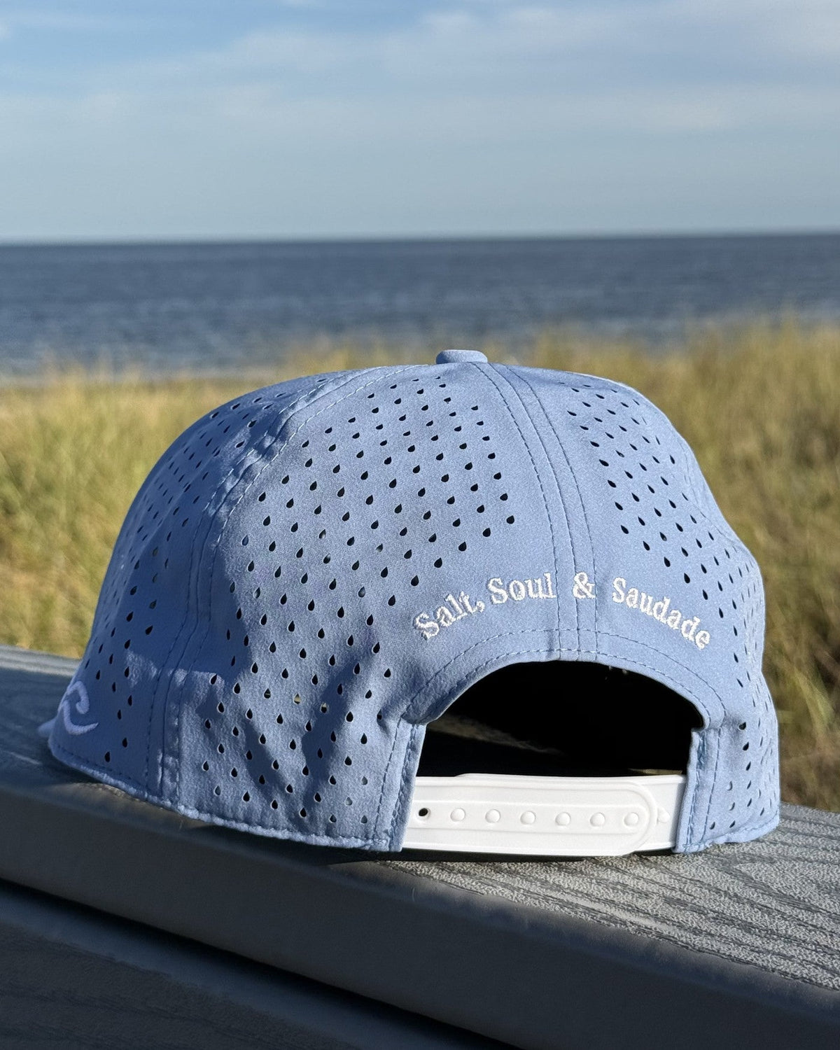 The back of the teen fit snapback, Salt, Soul and Saudade embroidered in white.