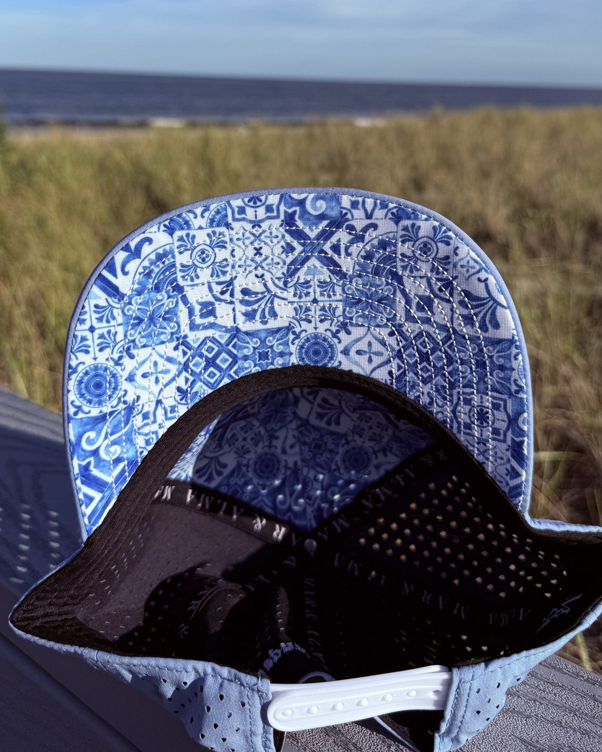 The teen fit snapback opened to show the azulejo tile print under the brim.