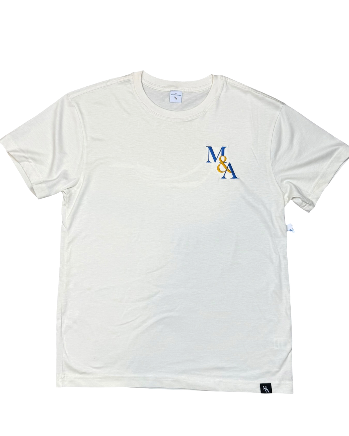 The Founders Tee in cream, M&A monogram embroidered at the left chest.